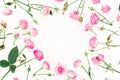 Stylish frame made of pink roses, buds and leaves on white background. Floral pattern. Flat lay, Top view. Royalty Free Stock Photo