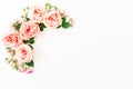 Stylish frame made of pink roses, buds and petals on white background. Floral composition. Flat lay, Top view. Royalty Free Stock Photo