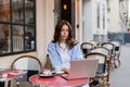 Stylish freelancer using laptop near coffee