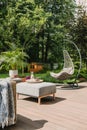 Stylish garden decoration with fancy egg chair and garden furniture Royalty Free Stock Photo