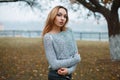 Stylish girl in a knitted sweater in a foggy autumn day Royalty Free Stock Photo