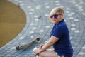 Stylish girl in sunglasses listens to headphones Royalty Free Stock Photo