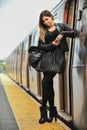 Stylish girl posing on the train platform in NYC Subway.