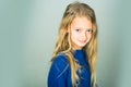 Stylish girl with pretty face on grey background. Beauty, kid fashion and healthy hair. Little girl with long hair