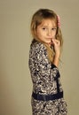 Stylish girl with pretty face on grey background. Little girl with long hair. Fashion model and beauty look. Hairdresser