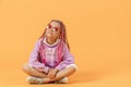 Stylish girl in rounded glasses with pink dreadlocks sitting, lo Royalty Free Stock Photo