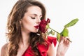 stylish girl sniffing rose with closed eyes