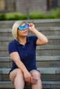 Stylish girl in sunglasses looks up to the sky Royalty Free Stock Photo