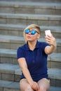 Stylish girl in sunglasses takes a selfie Royalty Free Stock Photo