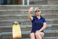 Stylish girl in sunglasses takes a selfie Royalty Free Stock Photo