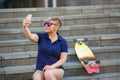 Stylish girl in sunglasses takes a selfie Royalty Free Stock Photo