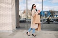 girl  walking with coffee and shopping eco bags after doing shopping. Royalty Free Stock Photo