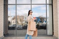 girl  walking with coffee and shopping eco bags after doing shopping. Royalty Free Stock Photo