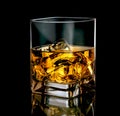 Stylish glass of whiskey with ice on black background