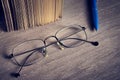 Stylish glasses lie on a wooden surface Royalty Free Stock Photo