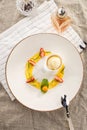 Stylish gourmet dessert with vanilla ice cream and fruit served on white plate at restaurant Royalty Free Stock Photo