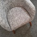 Stylish gray armchair on carpet floor