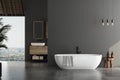Stylish gray bathroom interior with concrete floor, window with city view, dark wall, white bathtub, and sink with vertical mirror Royalty Free Stock Photo