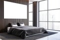 Stylish gray and dark wooden master bedroom corner with poster Royalty Free Stock Photo