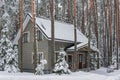 Stylish gray wooden house in a snowy forest Royalty Free Stock Photo