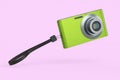 Stylish greeb compact pocket digital camera isolated on pink background Royalty Free Stock Photo