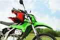 Stylish green cross motorcycle with helmet outdoors Royalty Free Stock Photo