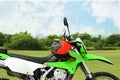 Stylish green cross motorcycle with helmet outdoors Royalty Free Stock Photo