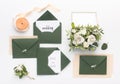 Stylish green envelopes with save the date text and accessories