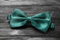 Stylish green satin bow tie on black wooden background, closeup Royalty Free Stock Photo