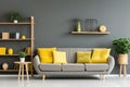 Stylish grey sofa with yellow pillows near green wall with wooden book shelf. Scandinavian interior design