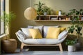 Stylish grey sofa with yellow pillows near green wall with wooden book shelf. Scandinavian interior design of modern living room.