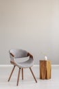 Stylish grey wooden chair in empty living room interior