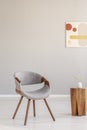 Grey wooden chair in empty living room interior with trendy wooden coffee table Royalty Free Stock Photo