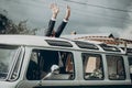 Stylish groom in retro car having fun, sitting inside with hands in the air and waiting for bride in the morning for wedding Royalty Free Stock Photo