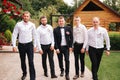 Stylish groomsman with groom standing on the backyard and prepare for the wedding ceremony. Friend spend time together