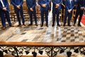Stylish groomsmen stand during the ceremony in the church