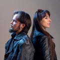 Stylish guy and girl in black leather jackets. Square image. Musical or biker theme. Advertising clothes for rock fans.