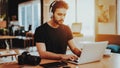 Stylish Guy in Headphones Use Laptop at Workplace