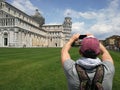 Stylish guy with a phone taking pictures of the Leaning Tower Royalty Free Stock Photo