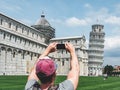 Stylish guy with a phone taking pictures of the Leaning Tower Royalty Free Stock Photo