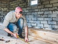 Stylish guy, working with tools on wood Royalty Free Stock Photo