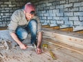 Stylish guy, working with tools on wood Royalty Free Stock Photo