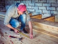 Stylish guy, working with tools on wood Royalty Free Stock Photo