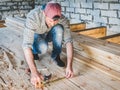 Stylish guy, working with tools on wood Royalty Free Stock Photo