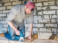 Stylish guy, working with tools on wood Royalty Free Stock Photo