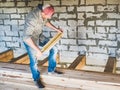 Stylish guy, working with tools on wood Royalty Free Stock Photo