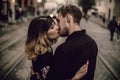 stylish gypsy couple in love kissing hugging in evening city street. woman and man gently embracing, romantic french atmospheric Royalty Free Stock Photo