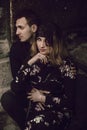 stylish gypsy couple in love posing in evening city street at old building. woman and man embracing, romantic french atmospheric Royalty Free Stock Photo