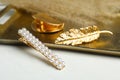 Stylish hair clips and gold tray on white table Royalty Free Stock Photo