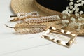 Stylish hair clips and hat on white wooden table Royalty Free Stock Photo